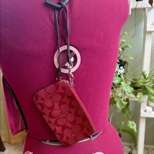 Coach vintage Y2K Signature red canvas wristlet and refined calf leather.
